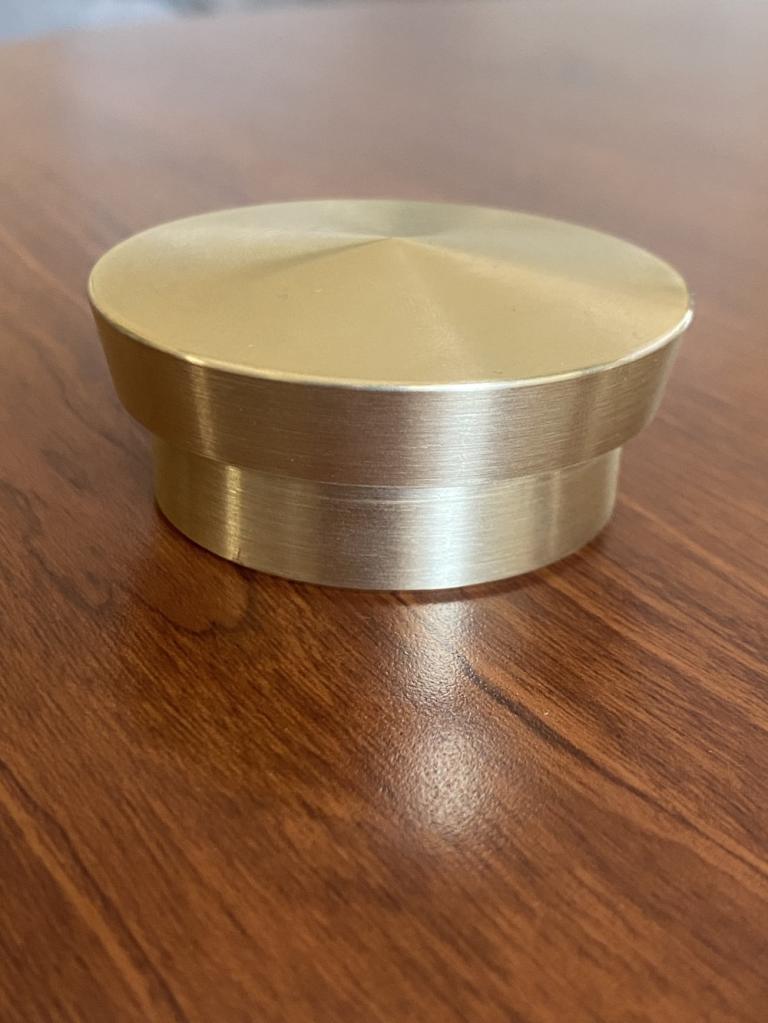 CNC turned brass cylindrical cap with stepped body and center-pointed flat top