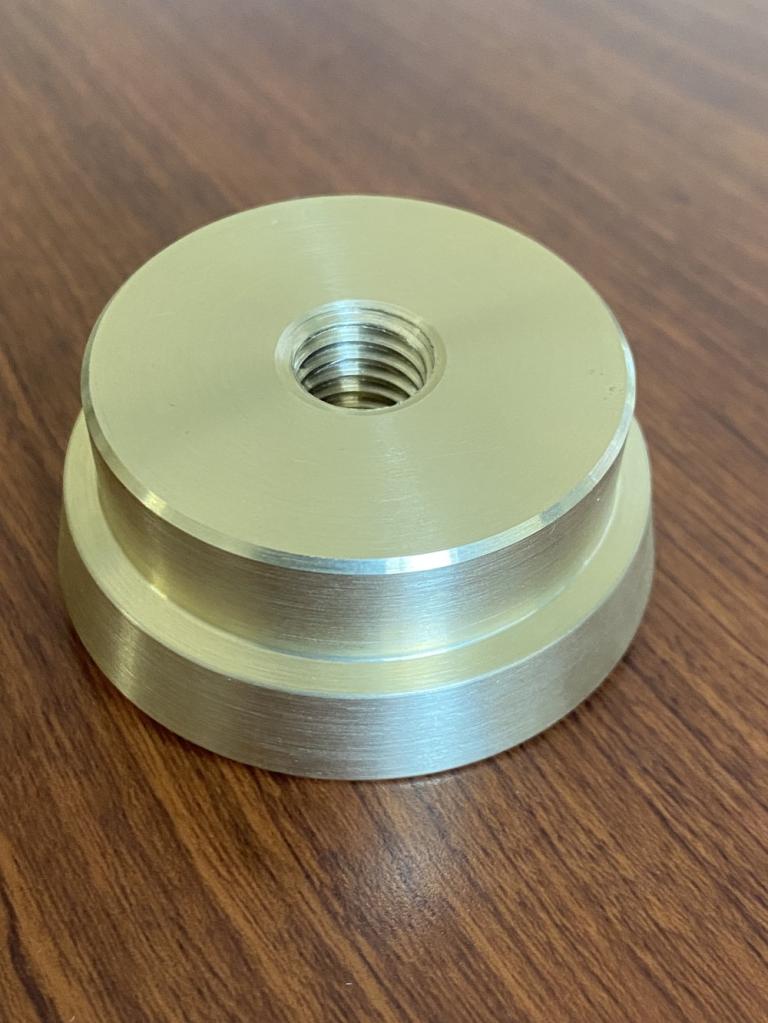 CNC turned brass stepped bushing with a center-tapped threaded hole
