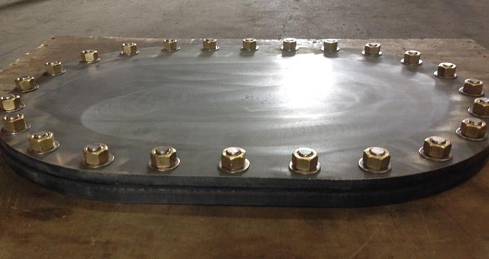 Oval steel plate secured with a ring of brass hex nuts and bolts, custom fabricated by Valley Nut & Bolt.