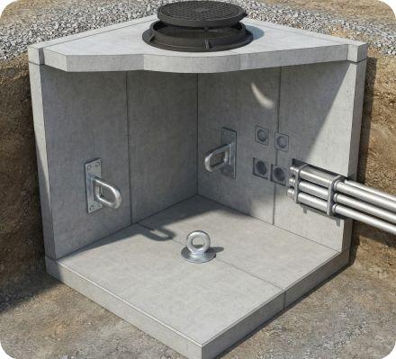 Cutaway illustration of a concrete manhole showing pulling irons mounted on the interior walls.